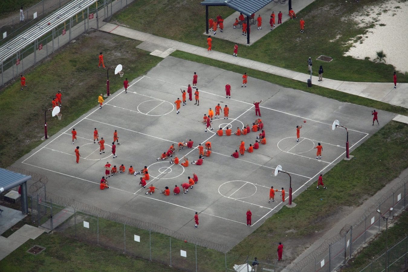 In an aerial view from a helicopter, detainees are seen at the Krome Detention Center, which some have called “hell on earth,” in Miami, Florida. On one occasion, they used their bodies to an ‘SOS’ that could be seen from above. | (Photo by Alon Skuy/Getty Images)