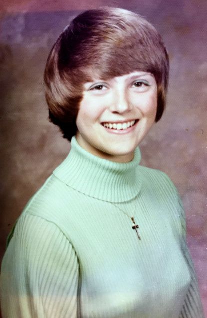 Ann Harmeier's senior photo, depicting her with a pixie haircut and wearing a light green turtleneck sweater.