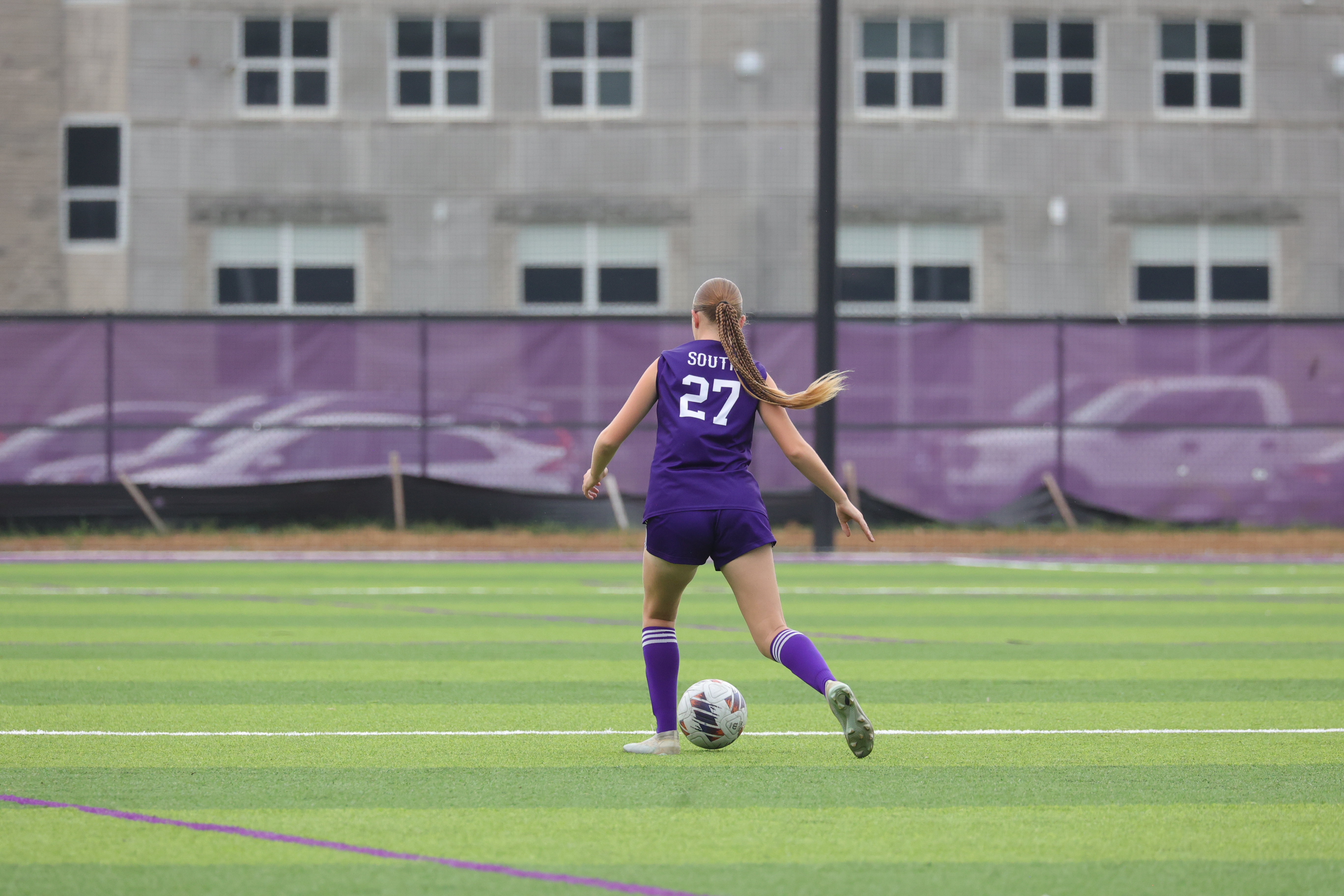 Charlotte Melick dribbles a soccer ball on the field at Bloomington High School South.