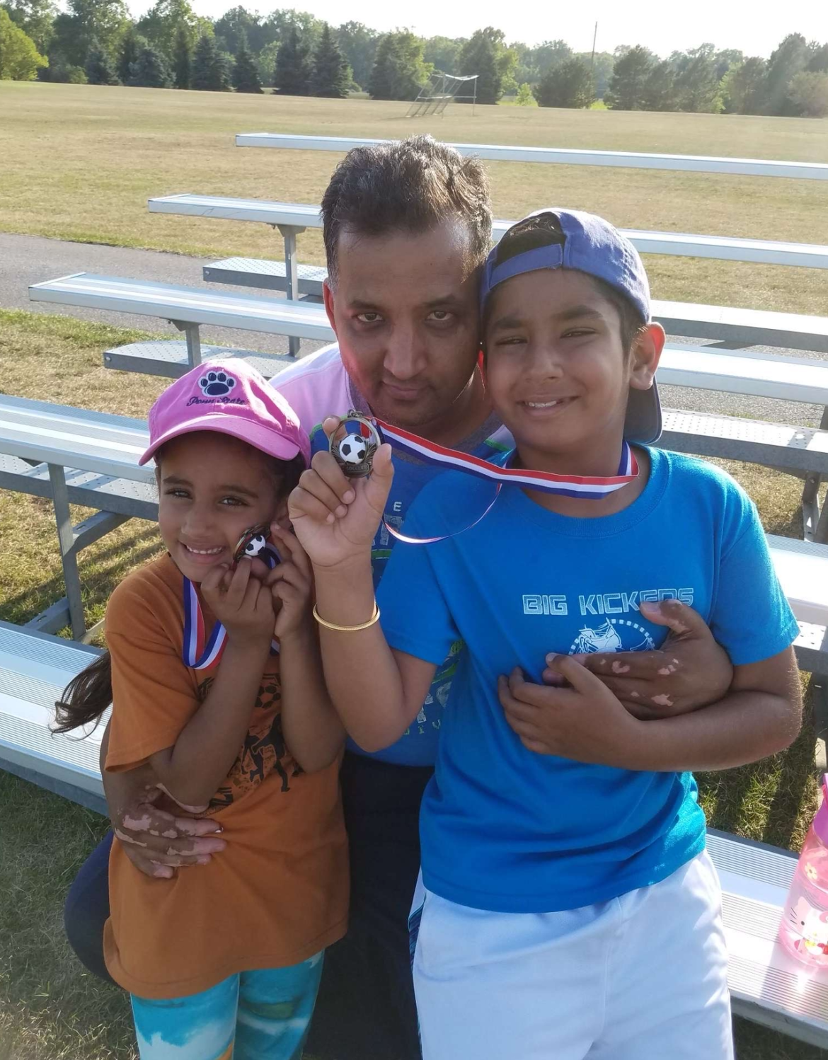 Paramjit hugs Kirat (right, as a child) and his daughter at a soccer tournament in the Midwest. Without his dad, “I am fighting every single day just to get through the day,” Kirat says. | Photo provided.