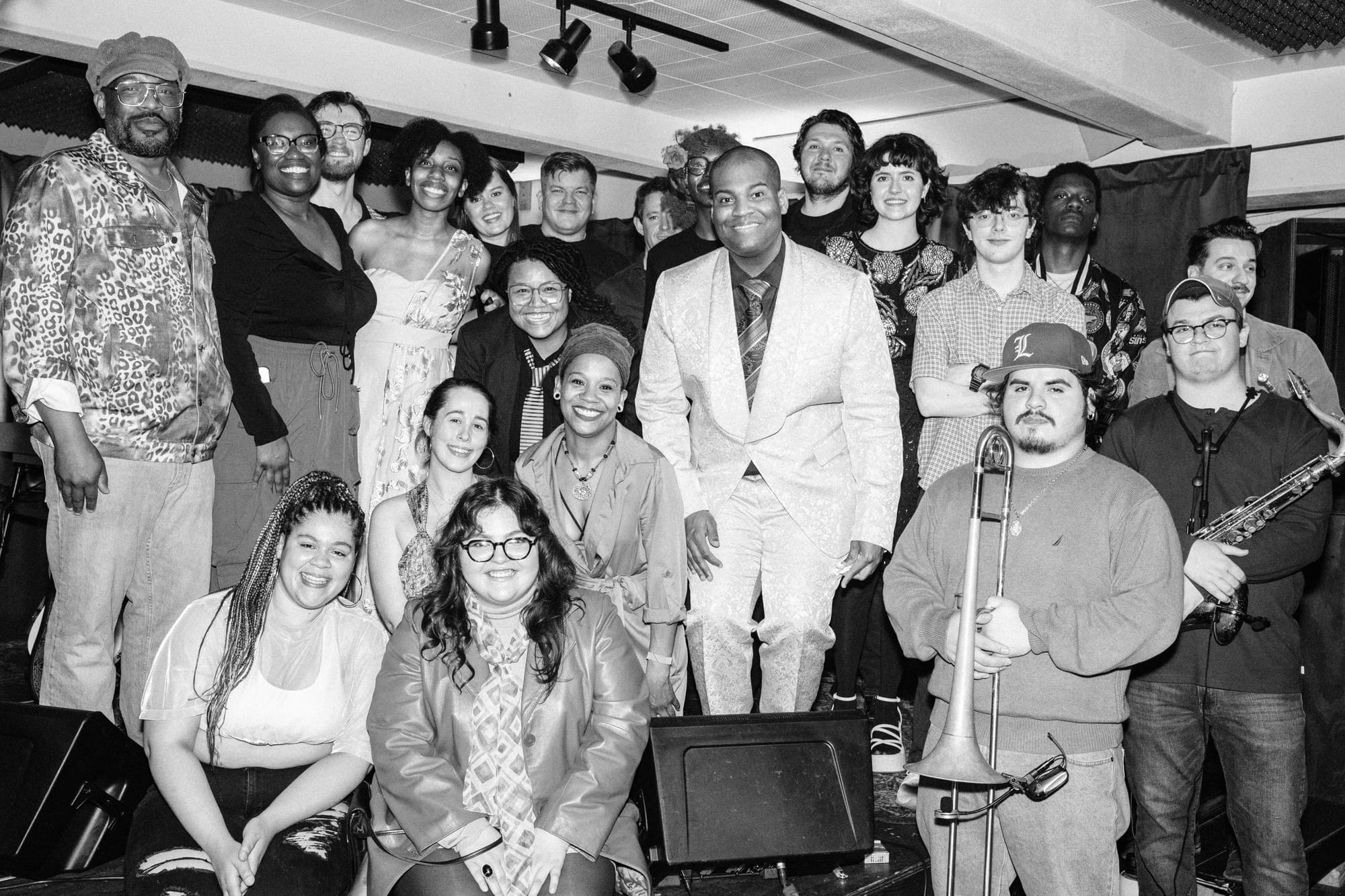 A crowd of performers poses for a group photo at The Blockhouse