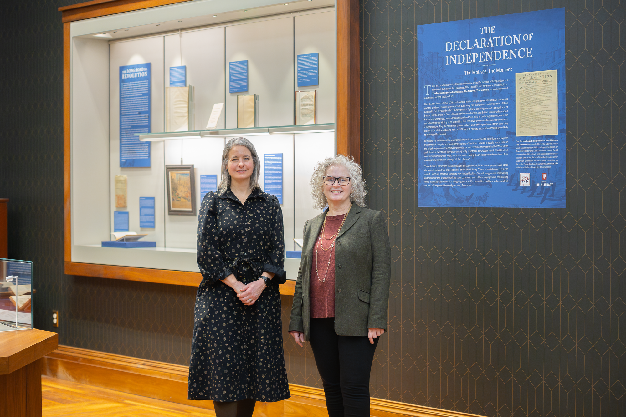 Exhibition designer Jenny Mack and curator Erika Dowell pose in front of one of the Declaration of Independence displays at the Lilly Library.
