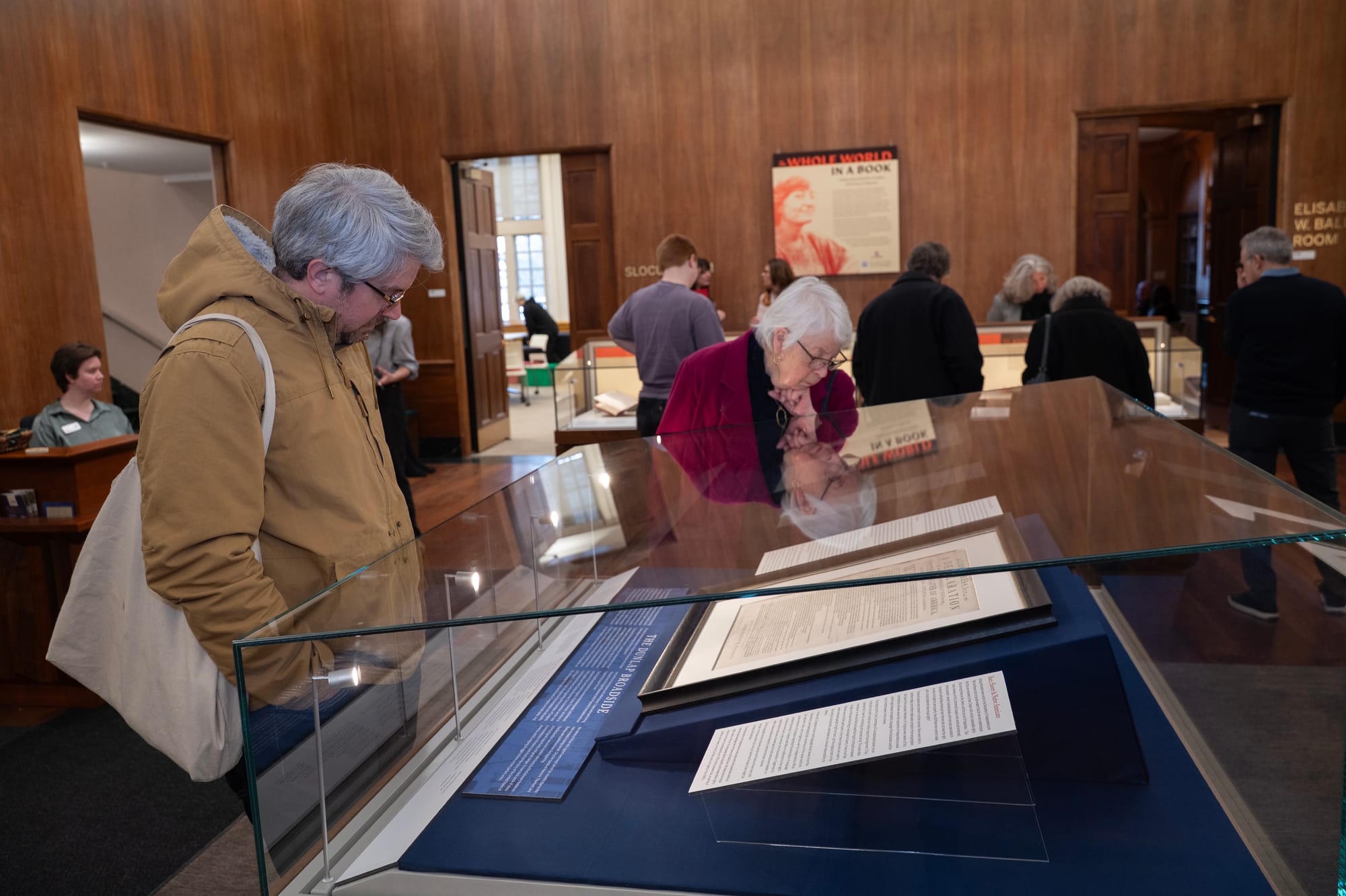 A man and a woman view an authentic copy of the Declaration of Independence through a glass display at IU's Lilly Library.