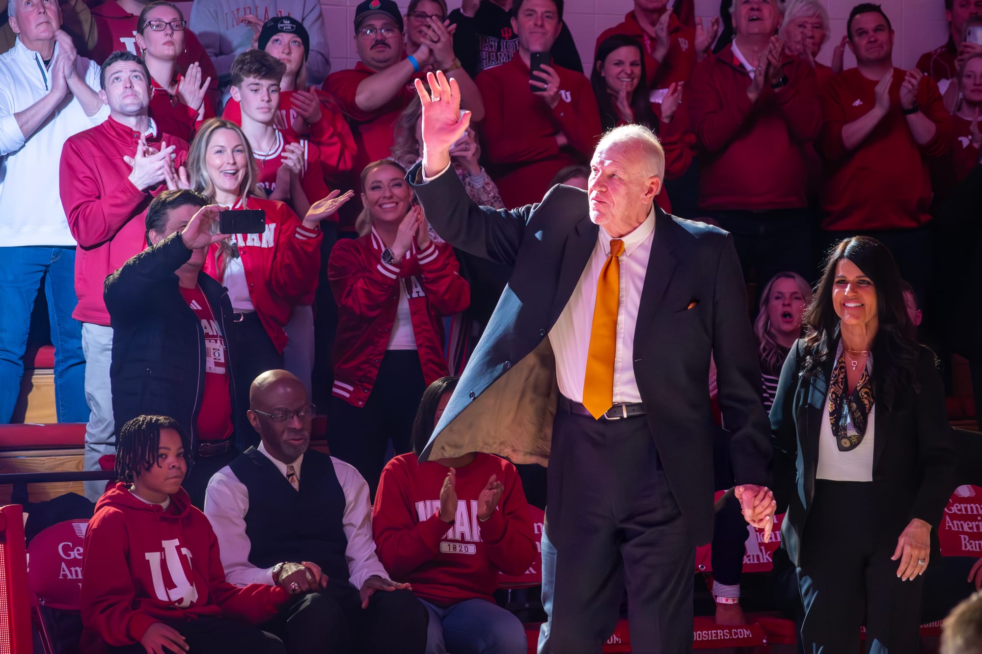 Kent Benson walks out in front of a large crowd predominantly wearing IU-branded clothing
