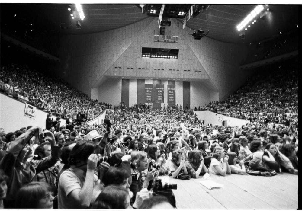 a black and white photo of IU's Assembly Hall in 1976. The arena is crowded with basketball fans.