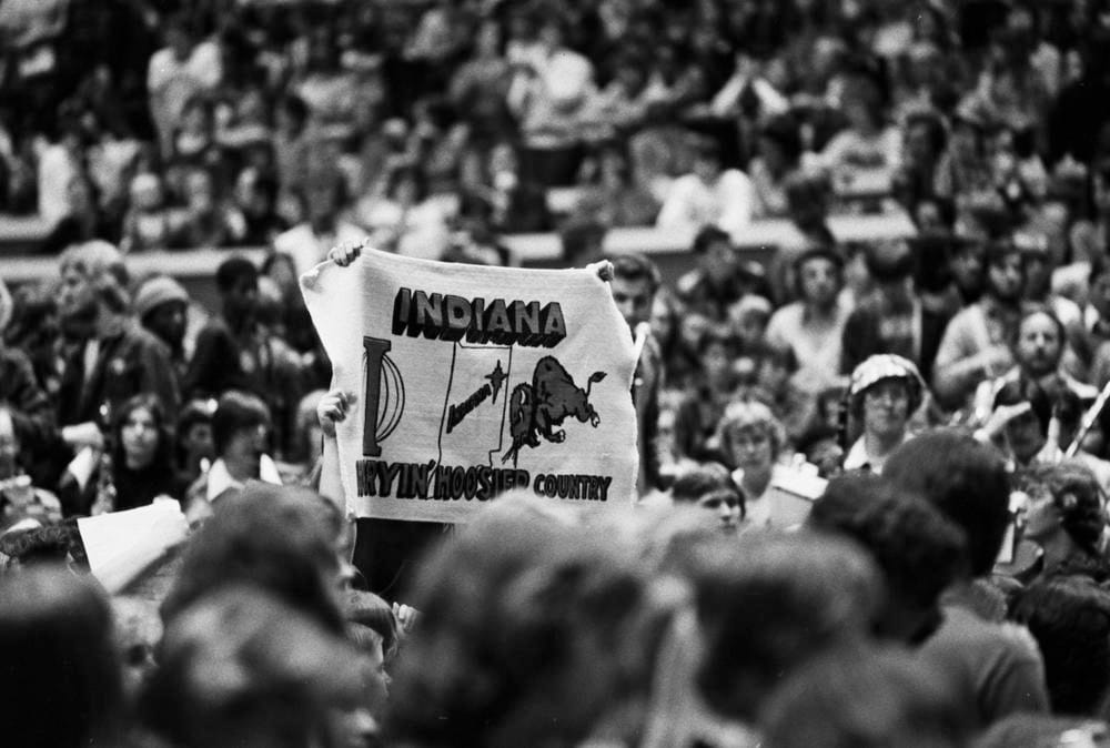 Indiana basketball fans hold up an "Indiana, Hurryin' Hoosier Country" banner depicting a bison and an outline of the state