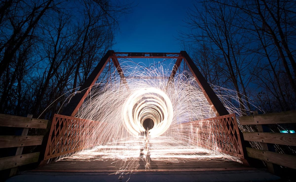 Nathan Clark spins steel wool on the Clear Creek Trail. Clark created this image by packing steel wool into a whisk, attachin