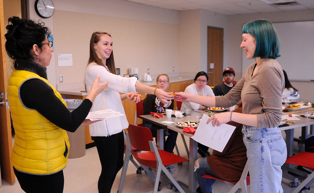 (l-r) Theresa Ochoa and Sarah Swank present Lizzy Chandler her completion certificate officially inducting her as a HOPE ment