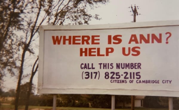 A billboard by Citizens of Cambridge City with the words "Where is Ann? Help Us" and a phone number to call with information