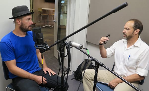 Chris Mattingly, left, tells Dave Torneo about his journey to the poet’s life at the Monroe County Public Library's Level Up