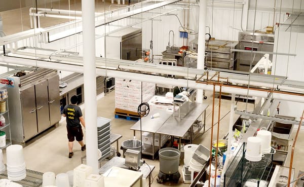 One World Enterprises' commissary has moved to a new location, bringing many members of their KitchenShare program with them.