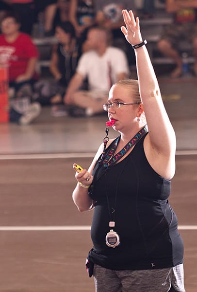 NSOs like Tofu do everything from run the game clock and scoreboard to manage the penalty box and track statistics. While the rules officially call for only seven NSOs, it ideally takes 12 to fully staff a game — all of whom are volunteers. | Photo by <a href="https://www.flickr.com/photos/claymanphotography/" target="_blank">Cory Layman</a>