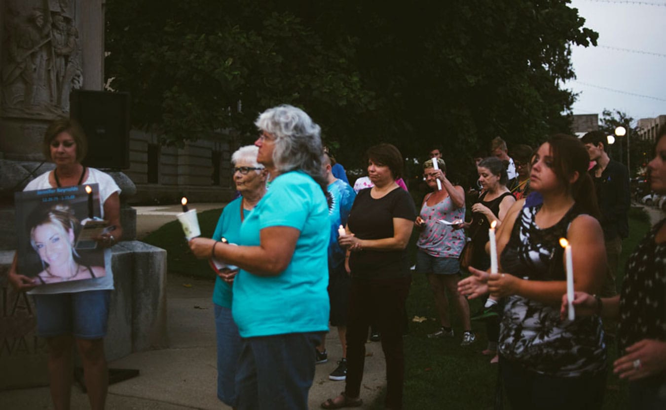 Attendees light candles during a vigil to remember loved ones lost to drug overdoses. | Photo by Natasha Komoda