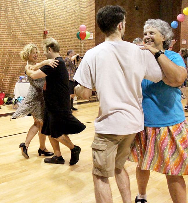 Cathy Meyer, right, the board chair of Bloomington Old-Time Music & Dance, says the physical contact with others that comes with contra dance is what makes it "a lot of fun." | Photo courtesy of Cathy Meyer