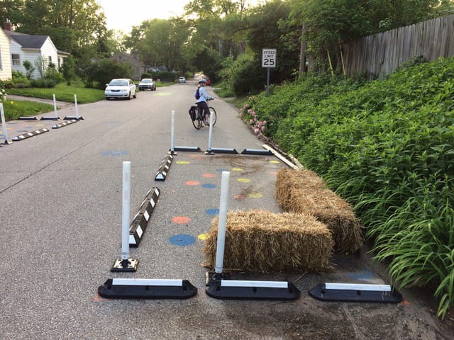 This image was from the Allen Street Greenway project. According to the website, “This project uses temporary materials including speed cushions and bump-outs in order to reduce motor vehicle speeds and increase comfort and safety for pedestrians and bicyclists on East Allen Street. This street was identified as a Neighborhood Greenway in the Bicycle and Pedestrian Transportation and Greenways System Plan. The temporary materials and pilot installation allow for residents and greenway users to provide feedback before committing to a permanent design for the Neighborhood Greenway.” | Photo by Jim Rosenbarger