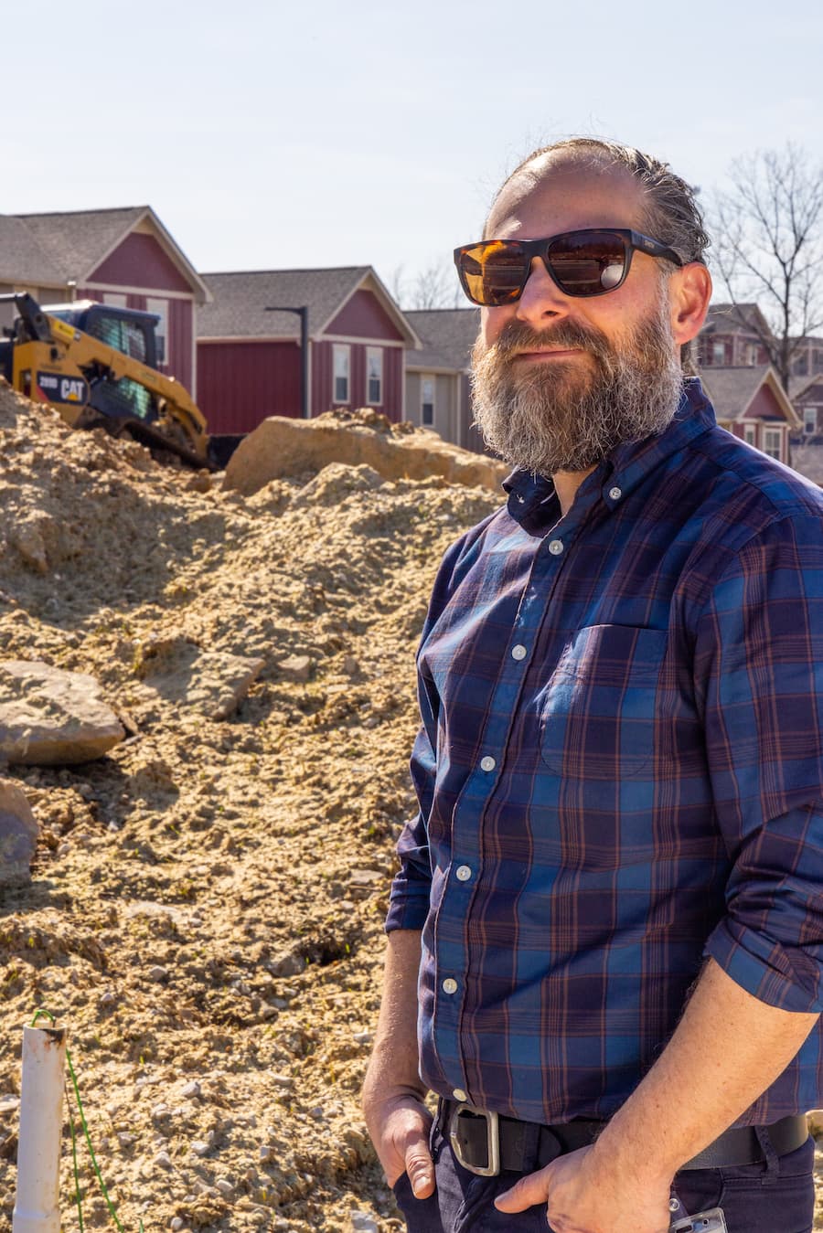 In a land trust, “the homeowner is just buying the home, not the land,” says Nathan Ferreira, director of real estate development at the Bloomington Housing Authority. Ferreira is shown here at a land trust established by Summit Hill Community Development Corp., a nonprofit created by the housing authority. | Photo by Jim Krause