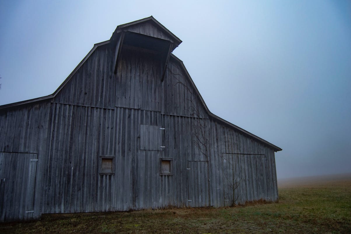 Grey barn on Tunnel Road, Unionville, Indiana — I had been waiting for the right morning for this scene. The barn stood out boldly against the thick fog. I wanted to give the feeling that something was around the corner or off out in the field. I imagined how it would have looked in the morning ready for its purpose to the farmer.