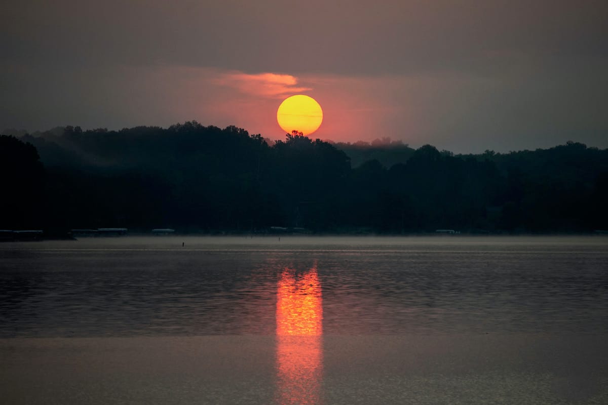 Sunrise on Lake Lemon, Monroe County, Indiana — The air was thick with smoke from forest fires. When the sun was cresting the horizon, the edges were so sharply defined. The scene was so dynamic and mysterious. I set my tripod up to get the clearest shot I could.