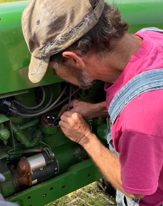 Mike Hughes tinkers with a distributor.