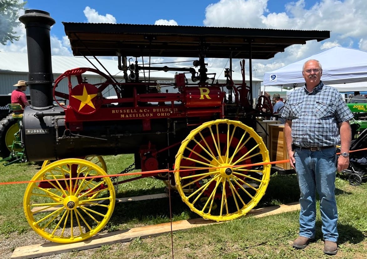 Tim Deckard, president of the Monroe County Antique Machinery Association, during the association’s show in May at the Monroe County Fairgrounds. He’s standing in front of an early 1880s Russell 10-horsepower steam tractor, which was first restored and exhibited in 1980 by Bob (“Papaw”) and Margie Hughes, then re-restored in 2023 by Bob (grandson) and Margaret Barnes. | Limestone Post